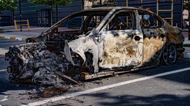 Bucha, Ukraine - May 22, 2022: a car burned in the bombed-out yard. Consequences of the occupation of a peaceful city by Russian troops High quality photo