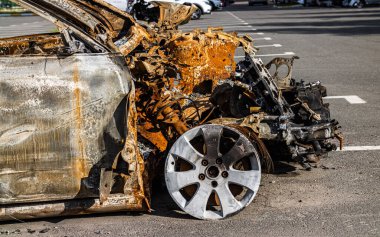 Bucha, Ukrayna - 22 Mayıs 2022: Bombalanan bahçede bir araba yandı. Barışçıl bir şehrin Rus birlikleri tarafından işgal edilmesinin sonuçları.