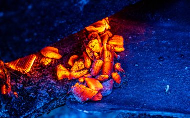 Hot coals in the grill, background, glowing coals in the background, mid view. High quality photo.