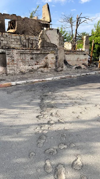 Traces on the pavement tile from the explosion of a mortar shell. The concept of war, the suffering of the civilian population. Racism. High quality photo.