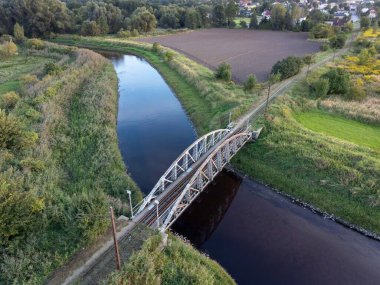 Old steel tram bridge over the Ner River in the city of Lutomiersk, Poland.