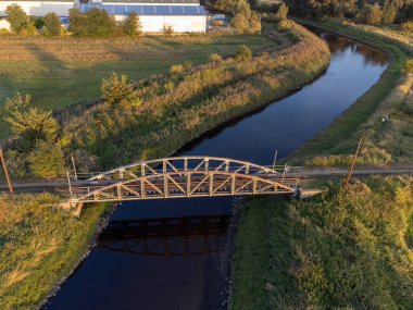 Old steel tram bridge over the Ner River in the city of Lutomiersk, Poland.