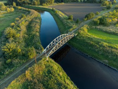 Old steel tram bridge over the Ner River in the city of Lutomiersk, Poland.