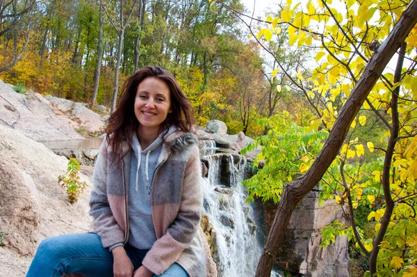 Happy Woman Coat Sitting Waterfall Autumn Nature Copy Space — Stock Photo, Image