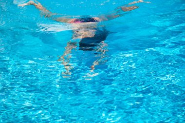 woman swimming under blue water. summer vacation. underwater.