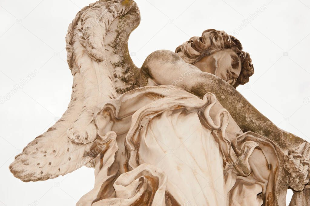 Angel with whips close view ancient marble statue sculpture historical landmark in Rome, Italy.