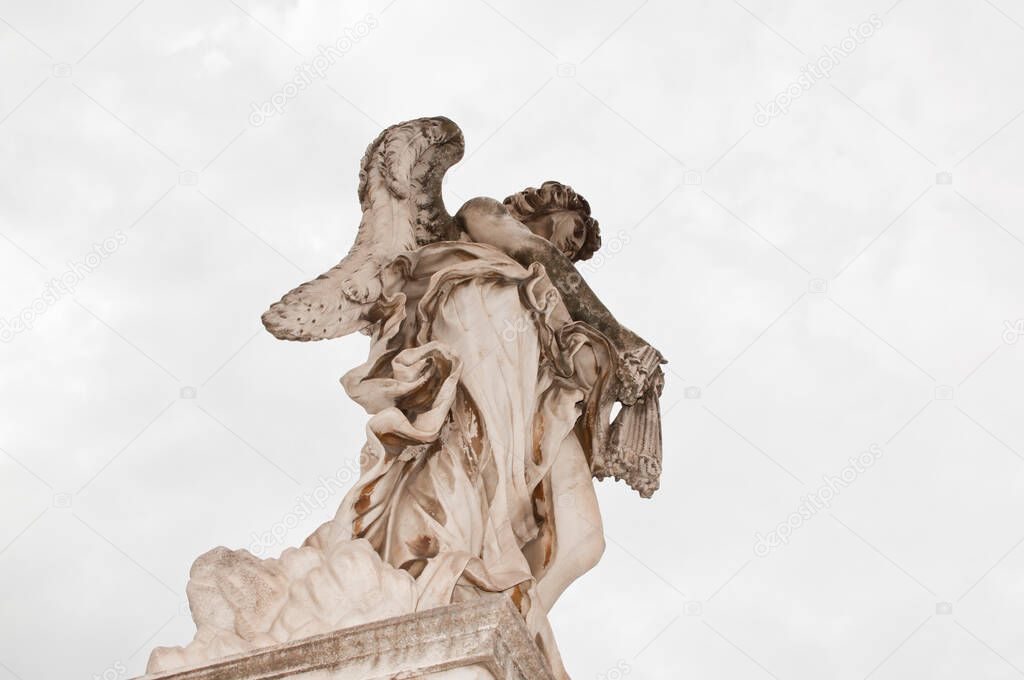 Angel with whips ancient marble statue sculpture historical landmark in Rome, Italy.