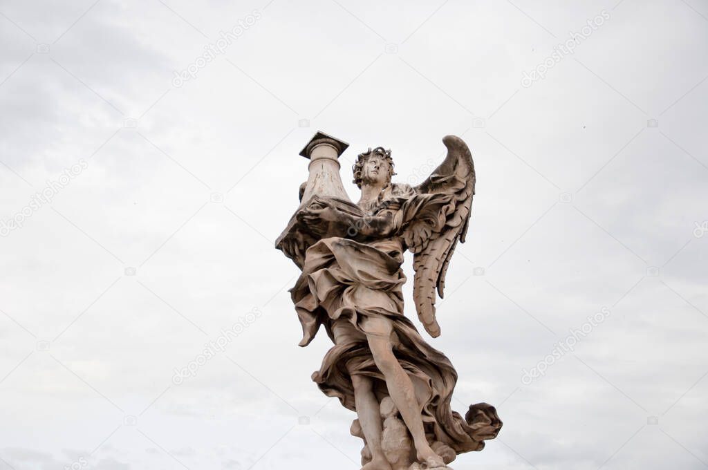 Angel with column ancient marble statue architectural sculpture historical landmark in Rome, Italy.