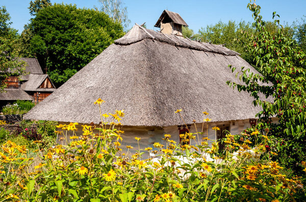 Authentic old village thatched house folk architecture in ethnographic open-air museum in Pyrohiv, Ukraine.