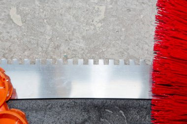 Beton duvar arka planında yeniden modelleme için sıva spatula ve fırça, yenileme.