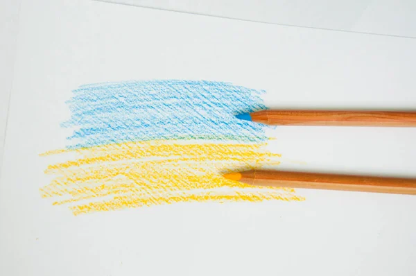 blue yellow flag drawn with pencils. ukrainian flag drawing. flag of ukraine color pencil. flat lay.