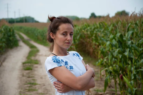 ukraine woman in field with ukrainian embroidery.