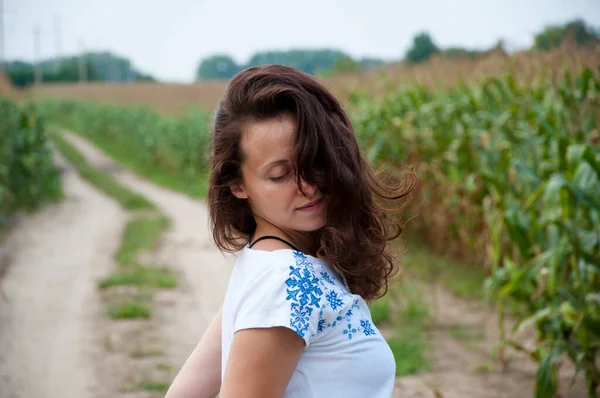 ukraine woman in field way with ukrainian embroidery.