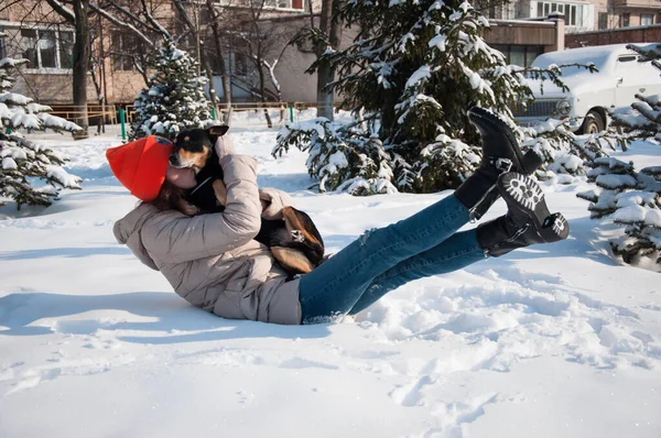 cute girl play with pet in winter. girl pet lover playing with her dog. girl outside with pet. playful pet outdoor with girl.