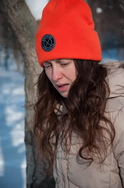冬日的女孩戴着橙色的暖和的帽子 在雪地里过冬 冬雪中戴着一顶暖和帽子的姑娘的冬季风尚 — 图库照片
