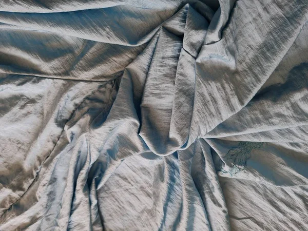 Abstract Background Textured Shiny Light Blue Fabric Irregular Creases Shadows — Stok Foto