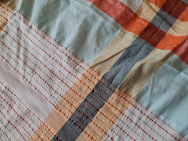 Abstract background textured white sarong with color combinations of lines forming a box