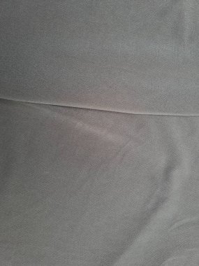 Katları bir gölge oluşturan soyut gri desenli kumaş arkaplanı