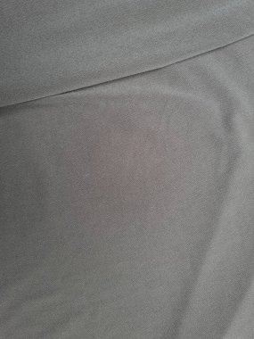 Katları bir gölge oluşturan soyut gri desenli kumaş arkaplanı