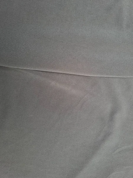 Katları bir gölge oluşturan soyut gri desenli kumaş arkaplanı