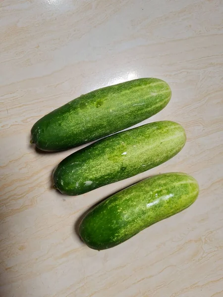 Tres Pepinos Verdes Combinados Con Fibroso Blanco Piso Porcelana Blanco —  Fotos de Stock