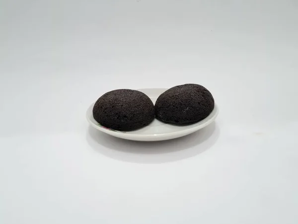Round chocolate brownies on a white plate