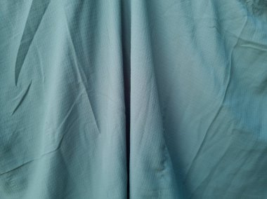 Soyut ve dokulu arkaplan katlanmış açık yeşil renkli kumaş