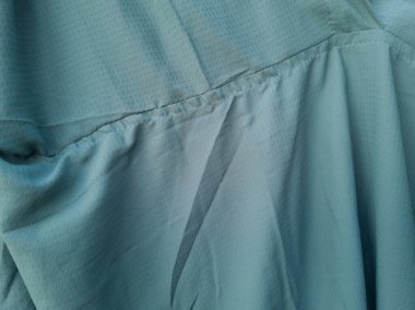 Soyut ve dokulu arkaplan katlanmış açık yeşil renkli kumaş