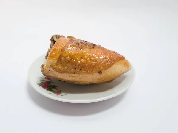 Crispy brown fried chicken on a white plate on a white background