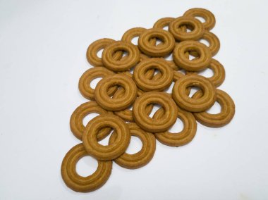 Yuvarlak bir tereyağlı pasta ve beyaz arka planda çok sayıda çikolata aromalı bir delik.