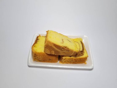 Beyaz kabın içinde yeşil pandan aromalı pandispanya keki.