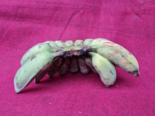Banane Semi Mature Verdi Gialle Fondo Rosso — Foto Stock