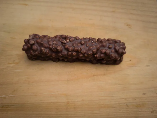 Snacks made of chocolate sprinkled with peanuts in it there is a wafer, named chocolate wafer
