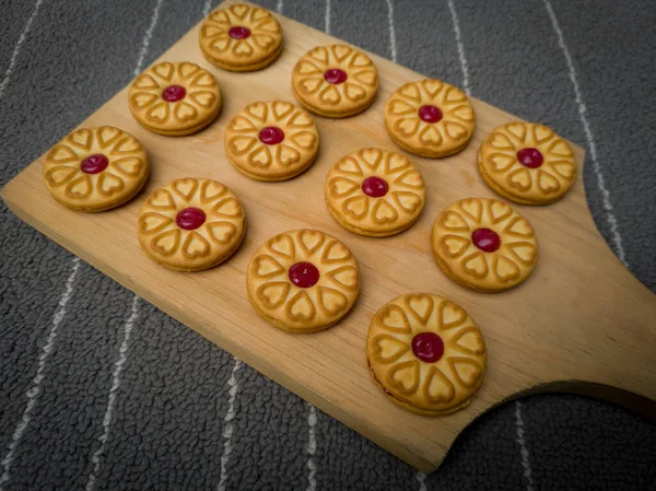 Biscuits filled with strawberry jam on the wood are perfect for a relaxing time