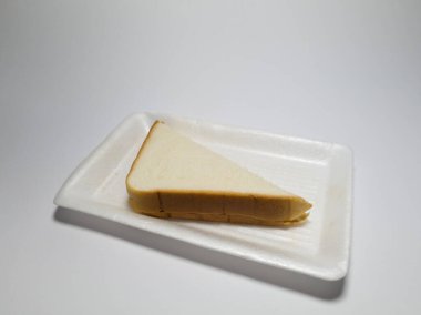 Beyaz bir kabın içinde ananas reçelli beyaz ekmek fotoğrafı.