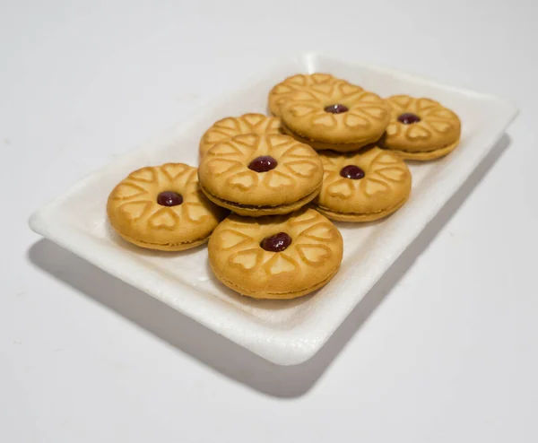 Biscuits filled with strawberry jam on the wood are perfect for a relaxing time