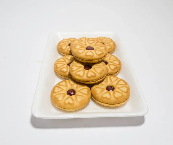 Biscuits filled with strawberry jam on the wood are perfect for a relaxing time