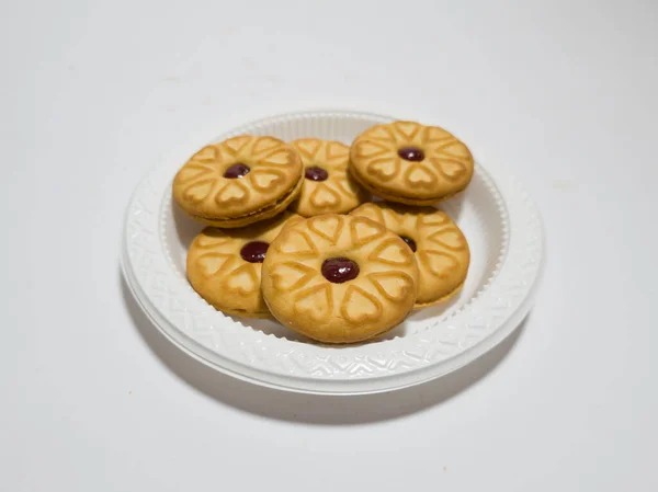 Biscuits filled with strawberry jam on the wood are perfect for a relaxing time