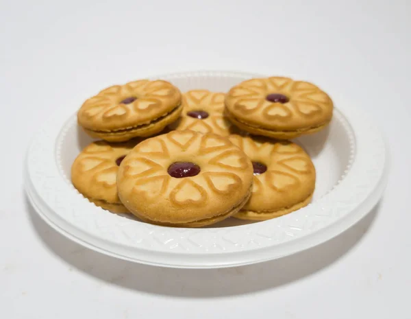 Biscuits filled with strawberry jam on the wood are perfect for a relaxing time