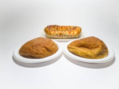 Kahverengi tatlı ekmek ve domates sosuyla doldurulmuş sosis.