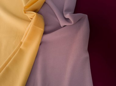 Kırmızı sarı ve açık kahverengi desenli soyut kumaş arkaplan