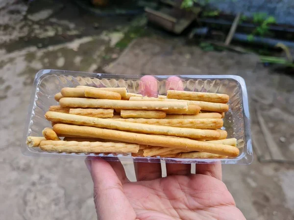 Hands Holding Light Snacks Namely Crunchy Sticks Savory Taste — стоковое фото