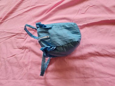 Blue bag for mukena with pink background