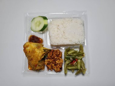 Typical dishes from Indonesia are mixed rice with fried chicken, fried chili sauce, stir-fried long beans and sliced cucumber