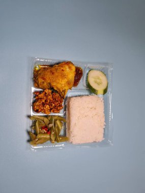 Typical dishes from Indonesia are mixed rice with fried chicken, fried chili sauce, stir-fried long beans and sliced cucumber