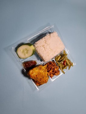 Typical dishes from Indonesia are mixed rice with fried chicken, fried chili sauce, stir-fried long beans and sliced cucumber