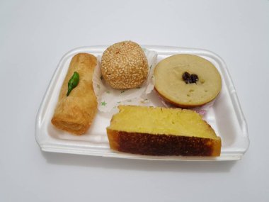 Snacks from the market consisting of mud cakes, apem cakes, spring rolls, steamed slices of bread, round bread filled with chocolate