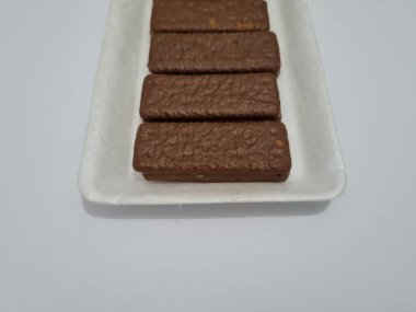 Snacks made from flour and other ingredients, namely chocolate-flavored biscuits
