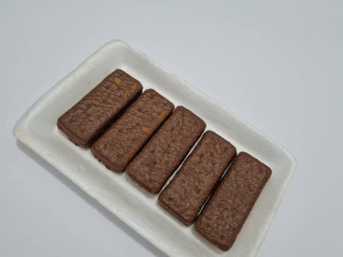 Snacks made from flour and other ingredients, namely chocolate-flavored biscuits