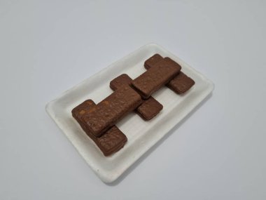 Snacks made from flour and other ingredients, namely chocolate-flavored biscuits